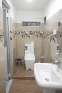 a bathroom with a toilet and a sink at Robert's-stay in Katunayaka