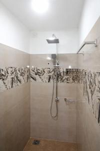 a bathroom with a shower with a shower head at Robert's-stay in Katunayaka