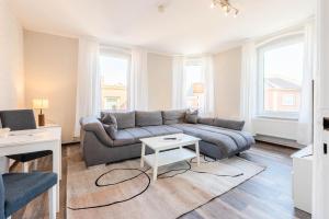 ein Wohnzimmer mit Sofa und Tisch in der Unterkunft Hafencity Apartments in Tönning