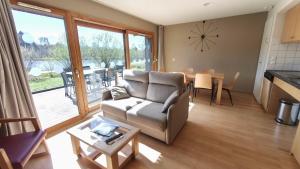 a living room with a couch and a table at Les Woodies in Xertigny