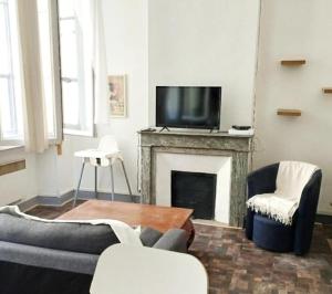 a living room with a tv and a fireplace at Massilia in Marseille