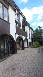 a building with a gate in front of it at Usługi Hotelarskie Jan in Ząbki