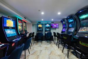 a room with a bunch of video game machines at Rox in Modriča