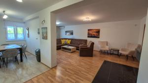 a living room with a couch and a table at MaMa Apartment in Seredʼ
