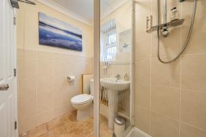 a bathroom with a toilet and a sink and a shower at Mariners Guest House in Plymouth +28 photos