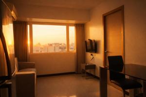 a hotel room with a view of a window at Extremeli Suites in Manila