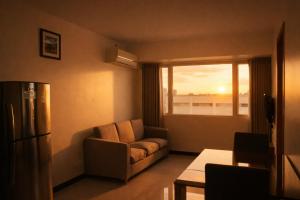 a living room with a couch and a window at Extremeli Suites in Manila