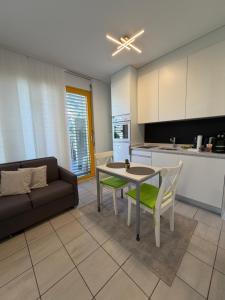a living room with a couch and a table and a kitchen at NiceStay in Lugano