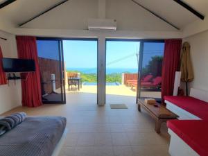 a room with a bed and a living room with sliding glass doors at Karo Villas in Ko Tao +15 photos