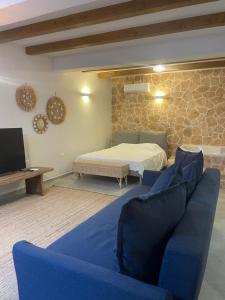 a living room with a bed and a couch at Villa Magiko in Poros +60 photos