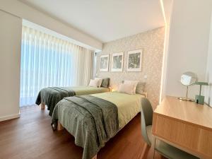 a bedroom with two beds and a window at Madeira Bliss II Prime Location with Pool and Parking in Funchal +12 photos
