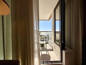 a room with a window with a view of a balcony at Madeira Bliss II Prime Location with Pool and Parking in Funchal