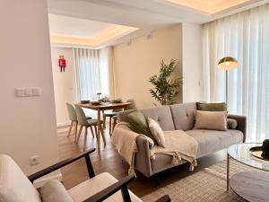 a living room with a couch and a table at Madeira Bliss II Prime Location with Pool and Parking in Funchal