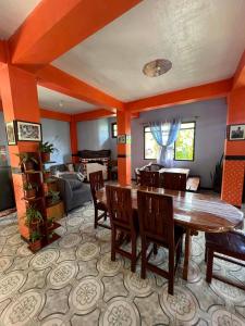 a living room with a wooden table and chairs at Banaue Greenfields Inn and Restaurant in Banaue