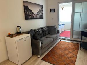 a living room with a couch and a table at MERVE BUTİK OTEL in Didim