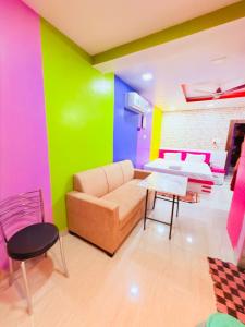 a living room with a couch and a table at Airport Sky Transit Suites in Rānchī