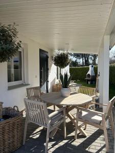 a wooden table and chairs on a patio at ZweiundMeer Bungalow 2 in Wiek auf Rügen