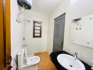 a bathroom with a toilet and a sink at Traditional villa in Gurgaon +11 photos