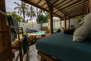 a bedroom with a bed and a swimming pool at The Swan Villa in Gili Trawangan