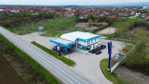 a blue gas station next to a highway at Rox in Modriča