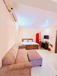 a living room with a couch and a bed at Airport Sky Transit Suites in Rānchī