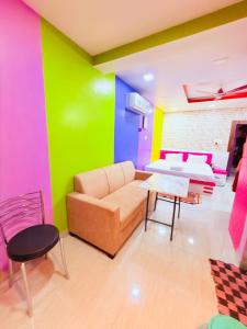 a living room with a couch and a table at Airport Sky Transit Suites in Rānchī +48 photos