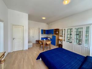 a bedroom with a blue bed and a table at Villa Ercole in Grado +13 photos