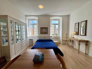 a bedroom with a bed and a table in it at Villa Ercole in Grado
