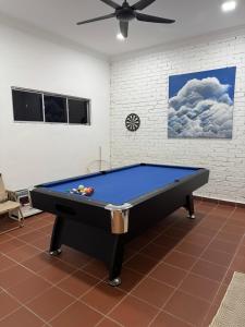 a pool table in a room with a ceiling at Dynz Cottage in Banting