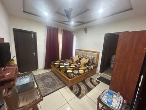 a bedroom with a bed and a desk in a room at Dadhwal B&B in Dharmsāla