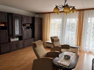a living room with a table and chairs at Penzion Borováček in Borová Lada