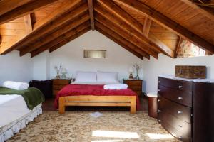 a bedroom with a bed and a wooden ceiling at Villa Dorothy - Mountain View Retreat, Polydrosos in Delphi