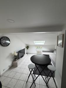 a room with a table and two stools in it at T3 duplex Cosy Centre-ville Longjumeau Proche RER TGV Orly in Longjumeau
