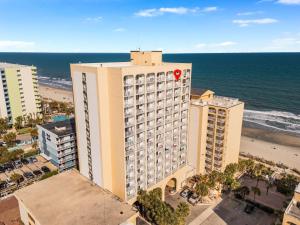a large building with a red circle on it next to the ocean at Beach View Condo in Myrtle Beach