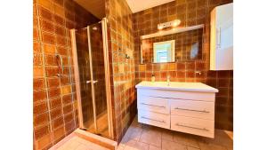 a bathroom with a shower and a sink and a mirror at 4 Bedrooms Cozy & Spacious Villa - Lalandia & Puttagrden & Femern in Rødby +23 photos