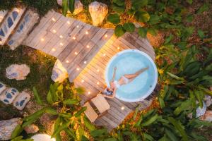 an overhead view of a woman in a swimming pool at Hatchu Khaoyai in Ban Bung Toei