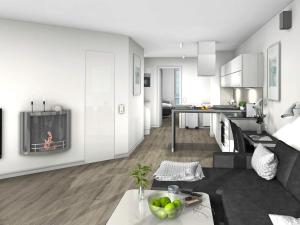 a kitchen and living room with a tv on a wall at 5 star holiday home in Wendtorf in Wendtorf