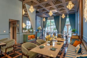 a restaurant with tables and chairs and a fireplace at Solaro Hotel & Spa Phu Quoc - Sunset Town Seaview & Fireworks in Phú Quốc