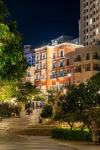 a lit up building in a city at night at Solaro Hotel & Spa Phu Quoc - Sunset Town Seaview & Fireworks in Phú Quốc