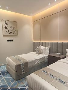 a hotel room with two beds in a room at لافيرا هاوس in Taif