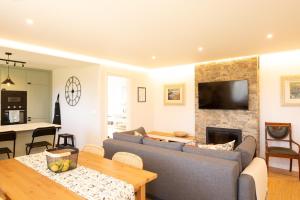 a living room with a couch and a fireplace at A Casiña dos Veiras - 3Km antes de Bruma in Santa Eulalia