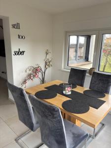 a dining room with a wooden table and chairs at Ferienhaus Weitblick Sankt Wendel in Sankt Wendel