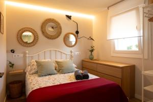 a bedroom with a bed with two shoes on it at A Casiña dos Veiras - 3Km antes de Bruma in Santa Eulalia