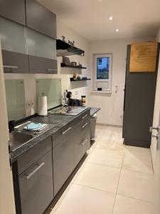 a kitchen with gray cabinets and a counter top at Ferienhaus Weitblick Sankt Wendel in Sankt Wendel