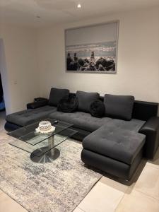a living room with a couch and a glass table at Ferienhaus Weitblick Sankt Wendel in Sankt Wendel