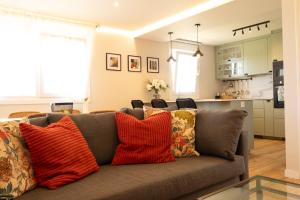 a living room with a couch with pillows on it at A Casiña dos Veiras - 3Km antes de Bruma in Santa Eulalia