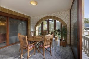 a dining room with a table and chairs at Villa Visanty with Private Pool & Access to Beach in Aigosthena