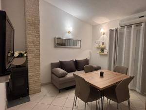 a living room with a couch and a wooden table at Apartments Lolo in Privlaka