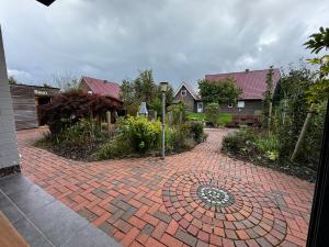 a brick driveway with a circle in the middle at Ferienhaus Kompass (ehemals Pension Hohlen) in Carolinensiel