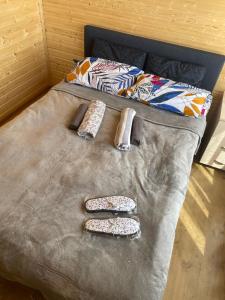 a bed with three remote controls on top of it at Guest house River side in Adishi